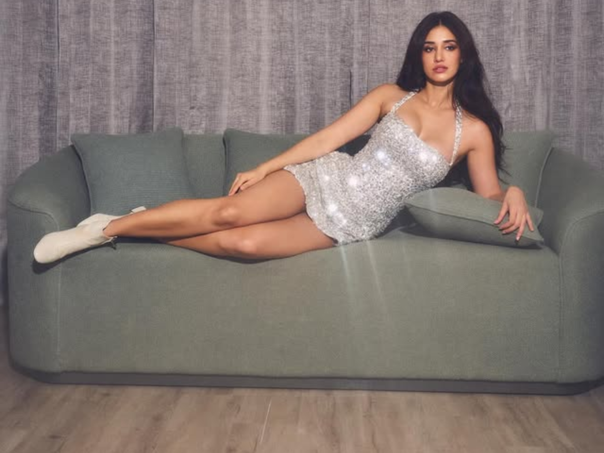Disha Patani strikes a killer pose lying on the sofa in a silver shimmery mini dress - Photo Gallery